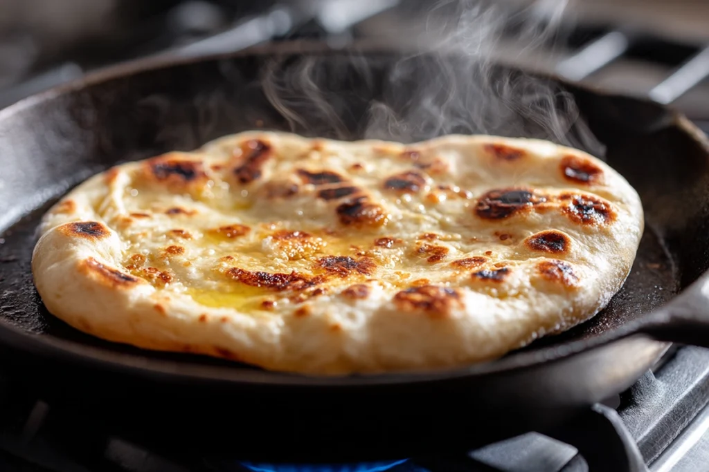 Creamy Butter Chicken With Soft Fluffy sauce simmering and thickening in a skillet