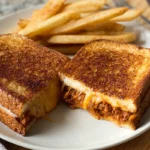 Grilled cheese sloppy joes served on a ceramic plate in a cozy home kitchen
