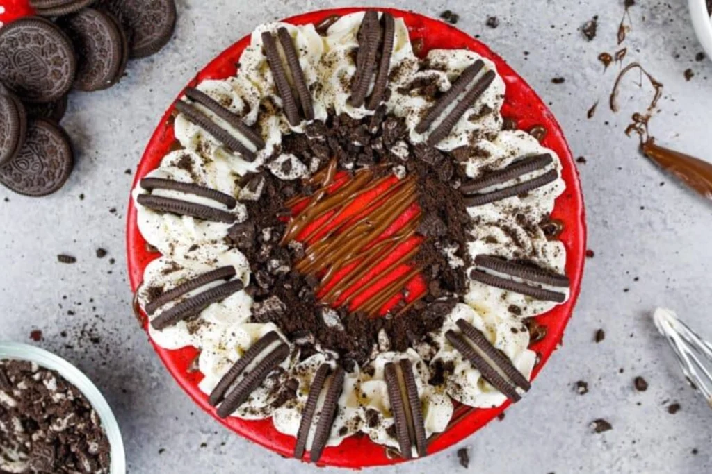 Cooling fresh Red Velvet Oreo Cheesecake in springform pan on wire rack