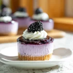 Mini Blackberry Lavender Cheesecakes topped with whipped cream and fresh blackberries