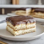 No Bake Eclair Cake served on a modern plate in a cozy home kitchen