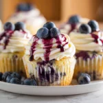 White Chocolate Blueberry Cupcakes plated fresh with creamy frosting