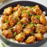 Sticky glossy 15-Minute Honey Garlic Chicken served over rice in a bright modern kitchen