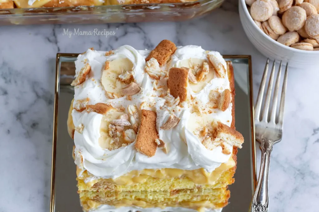 Creamy banana pudding poke cake slice with bananas and vanilla wafers