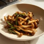 seafood mushrooms stir-fry served warm on a ceramic plate