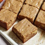 apple brownies with maple glaze plated in a cozy home kitchen