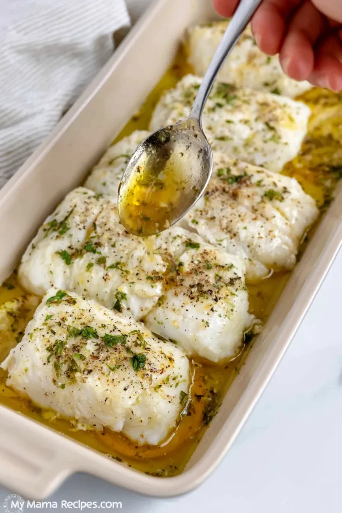 Lemon Garlic Butter Cod for an Easy 30-Minute Dinner 9 Baked lemon garlic butter cod with parsley and lemon slices in a casserole dish