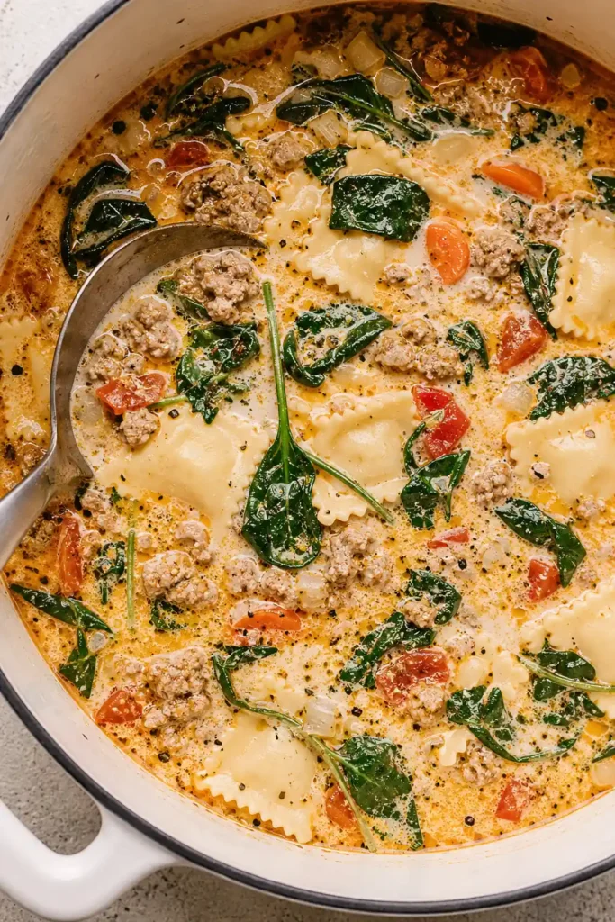 Creamy Ravioli Soup for a Cozy One-Pot Weeknight Dinner 7 Creamy Ravioli Soup close-up with ravioli spinach carrots and ladle