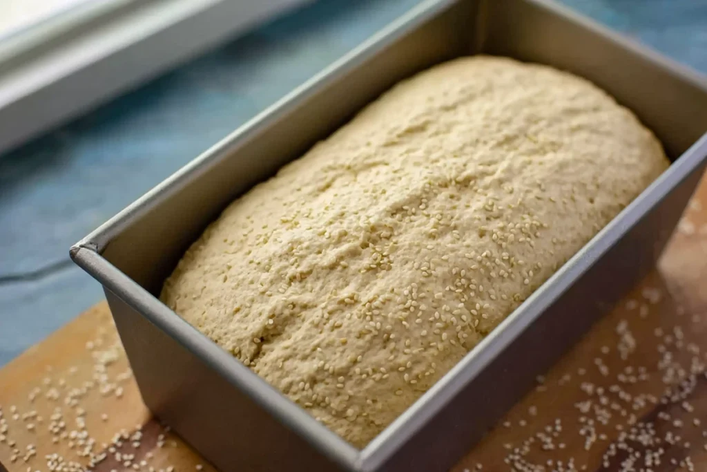 Perfect Quinoa Bread for Real-Life Toast, Sandwiches, and Comfort 8 perfect quinoa bread rising in a loaf pan before baking