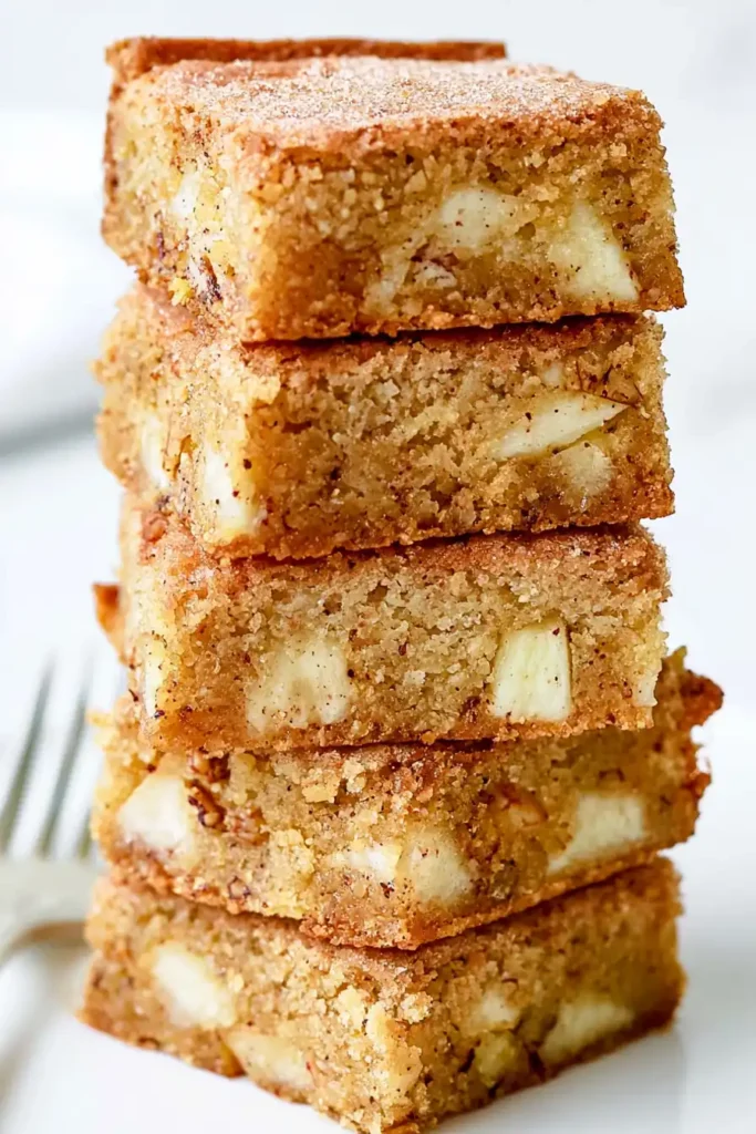 Chewy Apple Brownies with Cinnamon and Walnuts 5 Cooled apple brownies stacked to show cinnamon crumb, apples, and walnuts