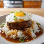 authentic loco moco served with rice beef patty gravy and egg on a modern plate