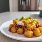 Chili Cheese Tater Tot Casserole – The Ultimate Comfort Food You’ll Crave Again 7 chili cheese tater tot casserole plated on white ceramic plate in modern kitchen with melted cheese and garnish