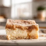 Churro Cheesecake: The Irresistible Dessert Mash-Up You’ll Crave Again and Again 11 close-up of churro cheesecake slice with cinnamon sugar crust and caramel drizzle in modern kitchen