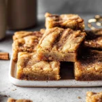 cinnamon swirl snickerdoodle blondies on modern plate in natural light