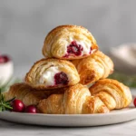 Cranberry Cream Cheese Crescent Bites – The Sweet & Tangy Holiday Favorite 7 golden cranberry cream cheese crescent bites on white plate in modern kitchen