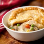 Cozy Comfort in a Bowl: Easy Slow Cooker Chicken Pot Pie 11 easy slow cooker chicken pot pie served with golden biscuit topping and creamy filling