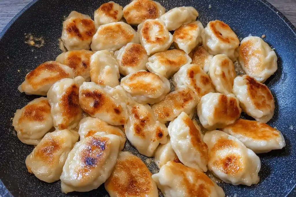 Golden pan-fried dumplings before adding sour cream sauce