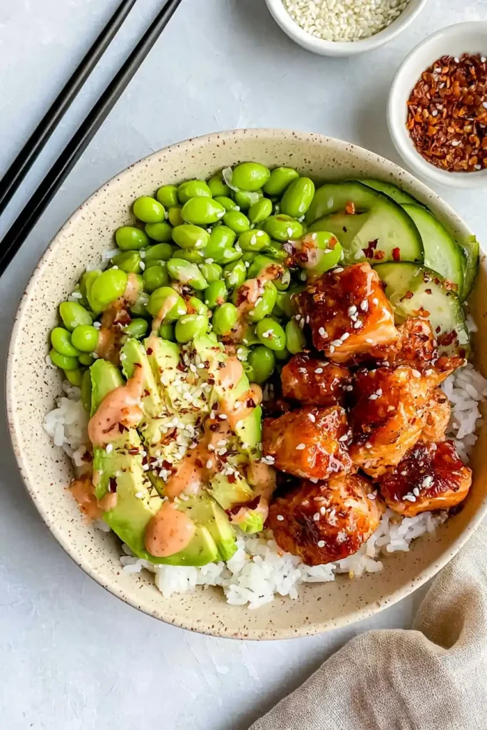 Honey Sriracha Salmon Bowls for a Quick Weeknight Dinner 4 Honey Sriracha Salmon Bowls with glazed salmon, avocado, cucumber, rice, and edamame