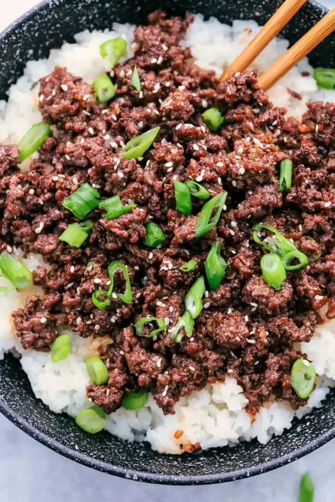 Korean Ground Beef Bowl for a Fast Weeknight Dinner 4 Korean Ground Beef Bowl served over hot white rice with green onions and sesame seeds