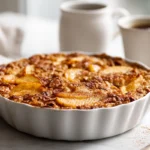 Cozy Oatmeal Apple Breakfast Bake for Chilly Mornings 11 oatmeal apple breakfast bake with golden crust and baked apple pieces in a white dish