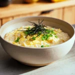 okayu with egg served warm in a modern ceramic bowl