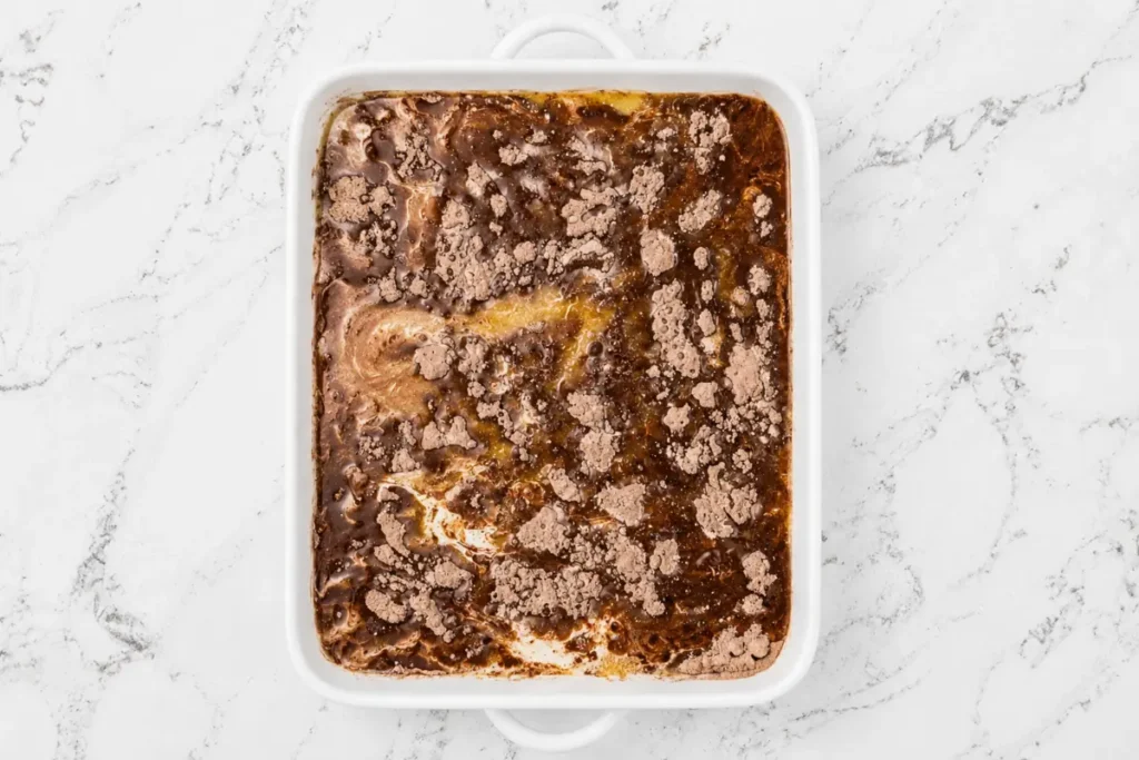 Oreo Dump Cake for an Easy Cookies-and-Cream Dessert 7 Oreo Dump Cake with melted butter poured over chocolate cake mix