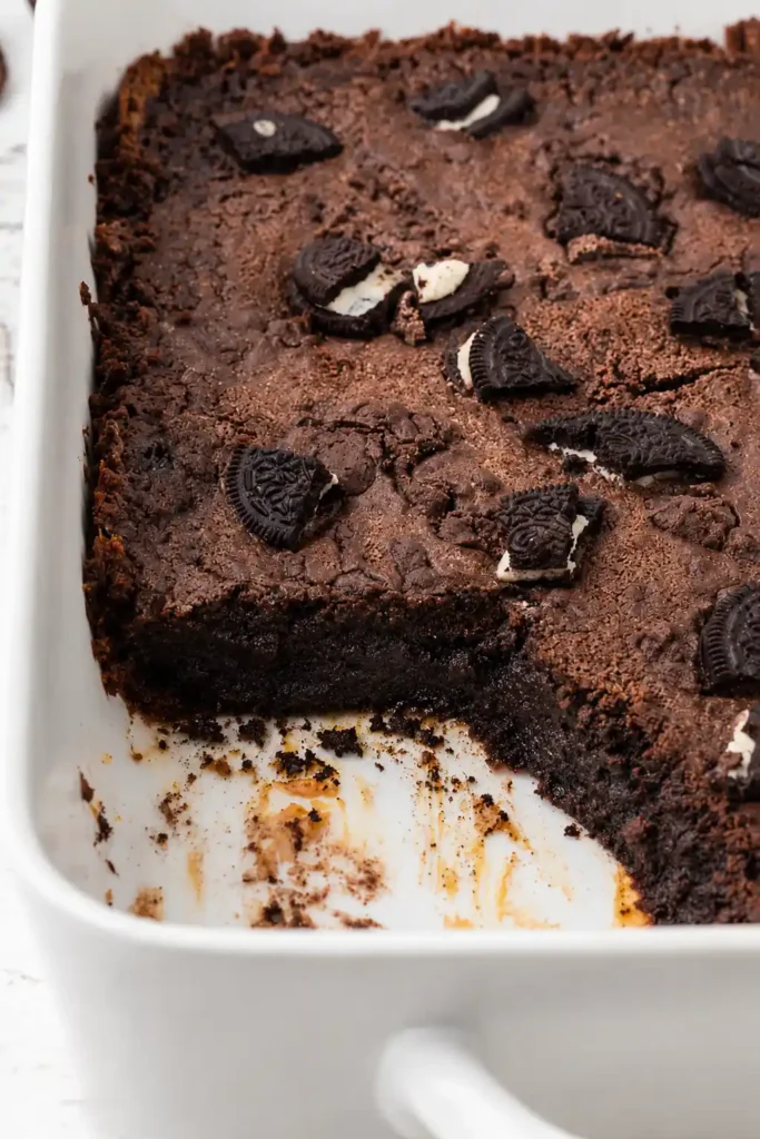 Oreo Dump Cake for an Easy Cookies-and-Cream Dessert 8 Oreo Dump Cake served from the baking dish with gooey chocolate and cookie layers