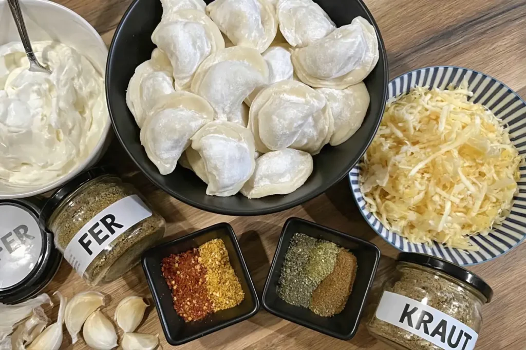 Ingredients for pan-fried dumplings with sour cream arranged on a wooden countertop