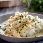 creamy ranch chicken crock pot served with mashed potatoes and fresh parsley in a modern kitchen