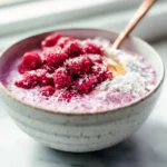 photorealistic raspberry chia pudding in a modern kitchen with natural lighting