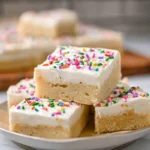 Soft and chewy Sugar Cookie Bars with creamy frosting on a modern ceramic plate