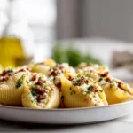 Sun-Dried Tomato Ricotta Stuffed Shells – A Cozy, Flavor-Packed Pasta Dinner 11 Sun-dried tomato ricotta stuffed shells plated on marble countertop in modern kitchen