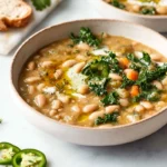creamy white bean soup in a modern kitchen with olive oil drizzle and herbs
