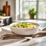White Chicken Chili: The Creamy, Cozy Bowl You’ll Crave All Season 7 Creamy white chicken chili topped with cheese, cilantro, and lime in a modern kitchen setting.