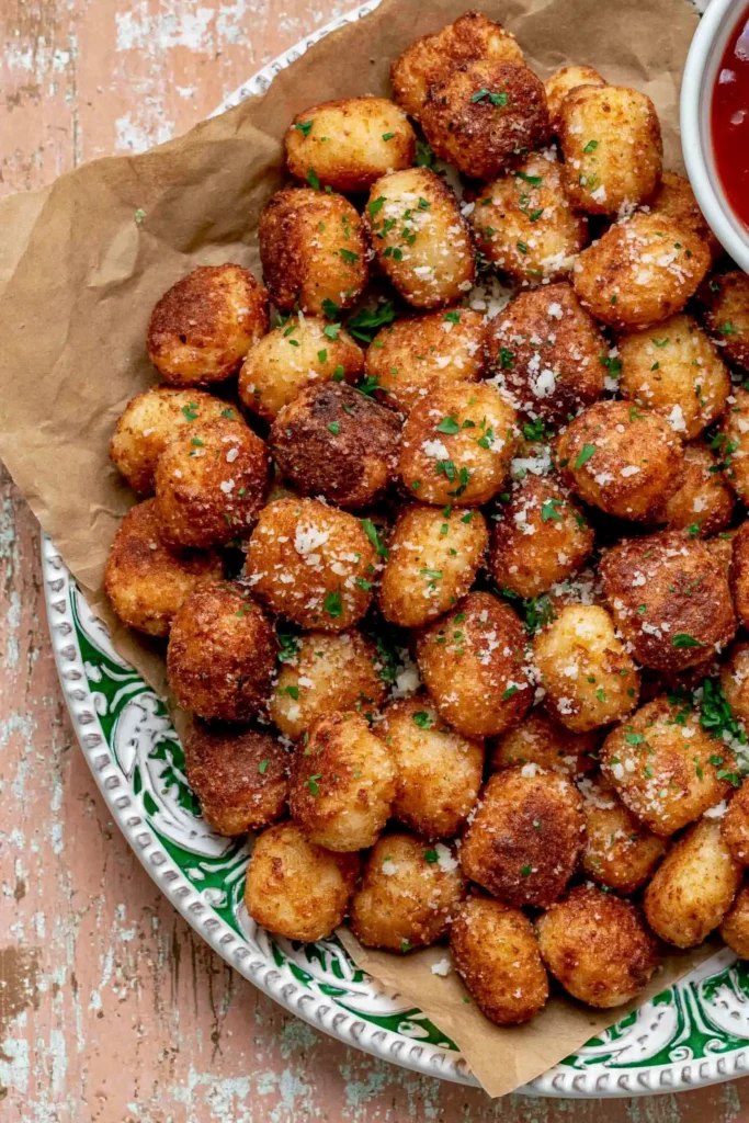 Crispy Air Fryer Gnocchi for an Easy No-Boil Side 9 Air Fryer Gnocchi served as a crispy appetizer with marinara and pesto