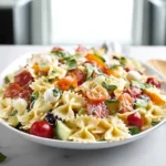 Bowl of bow tie pasta salad served on a modern kitchen counter