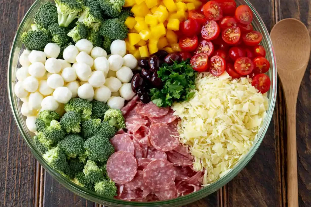 Bow Tie Pasta Salad with Salami, Mozzarella, and Italian Dressing 5 Bow Tie Pasta Salad with vegetables, salami, mozzarella, and olives before tossing