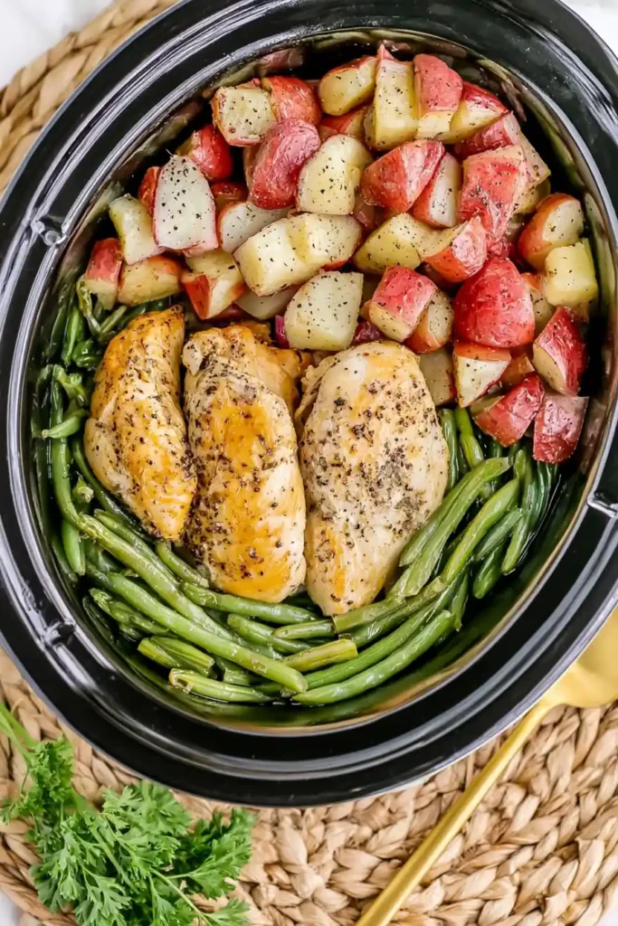 Seasoned Chicken Potatoes and Green Beans in the Slow Cooker 8 Cooked seasoned chicken potatoes and green beans in a slow cooker