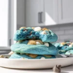 photorealistic cookie monster cookies on modern plate with vivid blue dough