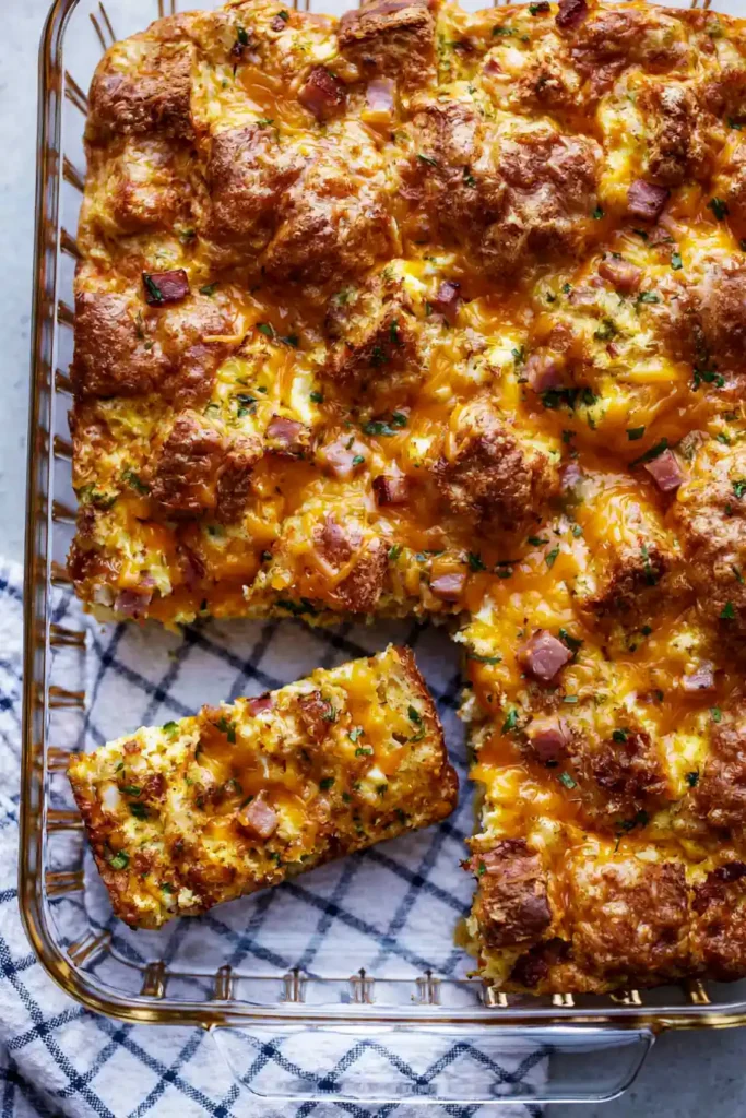 Crescent Roll Breakfast Casserole with Ham and Cream Cheese 3 Crescent roll breakfast casserole showing ham, eggs, shredded cheese, jalapeño, and parsley