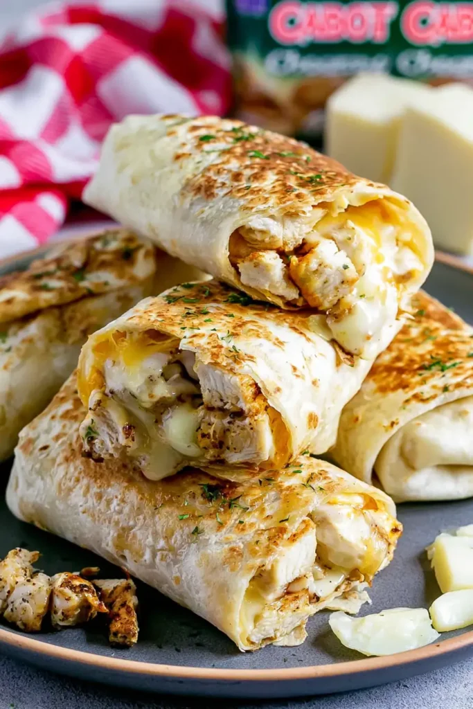 Cheesy Garlic Chicken Wraps for a Quick Weeknight Dinner 5 Crispy Cheesy Garlic Chicken Wraps with tightly folded edges and melted cheese
