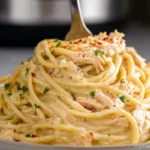 Crock Pot Cheesy Chicken Spaghetti served on a plate with creamy cheese sauce and chicken