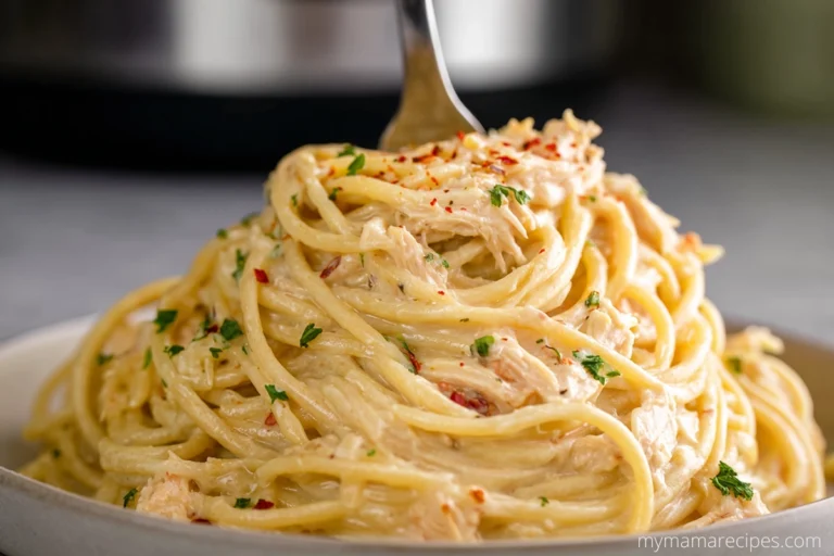 Crock Pot Cheesy Chicken Spaghetti served on a plate with creamy cheese sauce and chicken