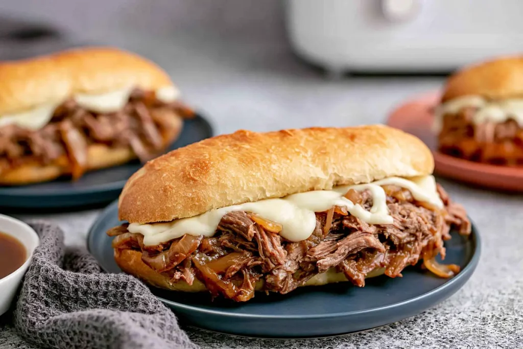Finished Crock Pot French Dip sandwiches with melted provolone on toasted hoagie rolls
