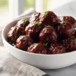photorealistic bowl of grape jelly meatballs in modern kitchen