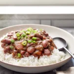 Photorealistic hero shot of Louisiana Red Beans and Rice in a modern kitchen