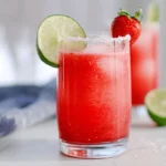 non-alcoholic strawberry margarita with lime garnish and sugared rim