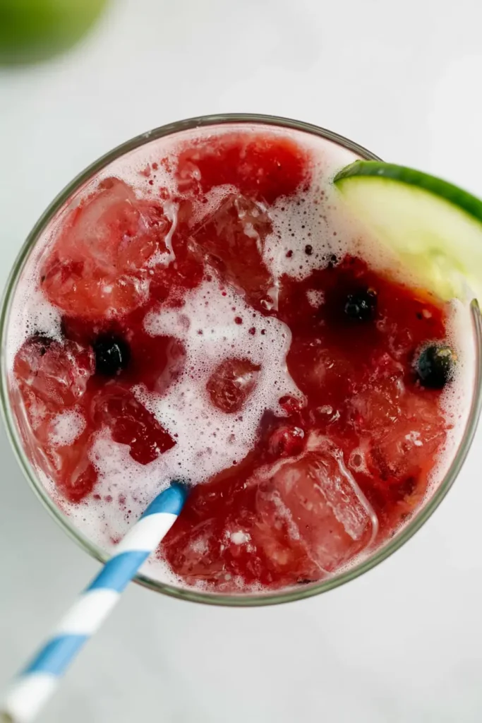 Non-Alcoholic Strawberry Margaritas with Fresh Lime and Seltzer 4 Overhead view of a non-alcoholic strawberry margarita with crushed ice and fresh lime