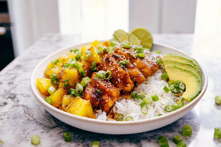 Pineapple Chicken and Rice plated on a white dish with pineapple glaze and rice in a modern kitchen