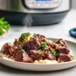 Overhead view of raw ingredients layered in a slow cooker for Garlic Butter Beef Bites